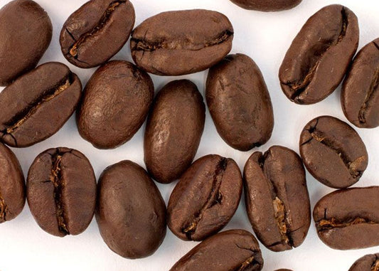 Coffee beans scattered on a white background